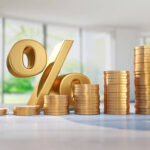 Ascending stacks of golden coins and percentage sign with empty sunny blurred apartment background